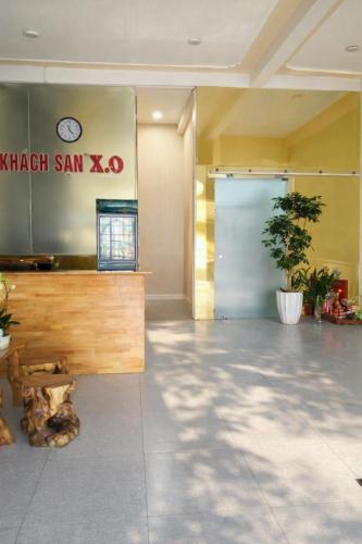 a lobby with a wooden counter and a blue door at Tam Ky XO Hotel in Tam Kỳ