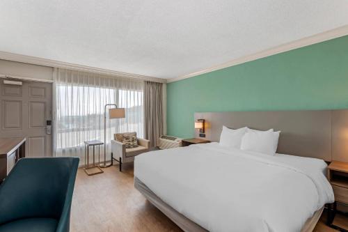 a hotel room with a large bed and a window at Comfort Inn & Suites Ormond Beach Oceanfront in Ormond Beach