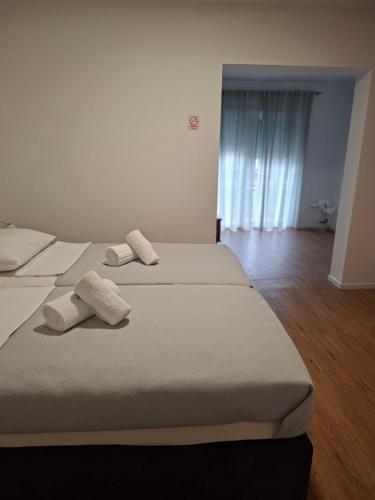 two beds in a room with two towels on them at Hotel Adria in Kaštela