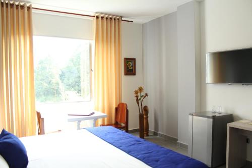 Una cama o camas en una habitación de Hotel Ventura