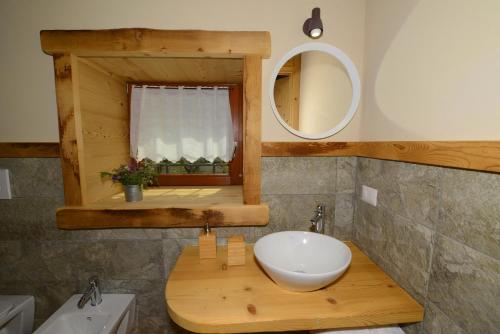 a bathroom with a white sink and a mirror at Il Faita in Passo del Tonale