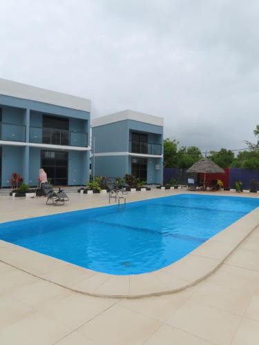 a large swimming pool in front of a building at Wayma Paradise Resort in Jambiani