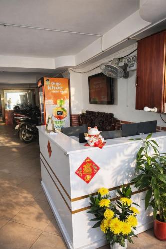 a restaurant with a counter with flowers on it at Thắng Hà Hotel in Ho Chi Minh City