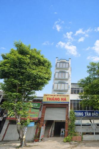 a tree in front of a tall building at Thắng Hà Hotel in Ho Chi Minh City