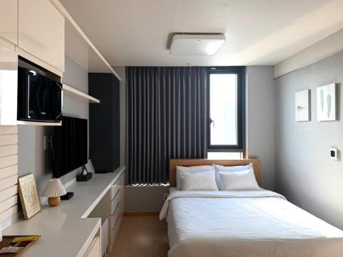 a bedroom with a large bed and a television at Sky Star in Incheon