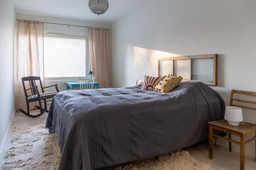a bedroom with a large bed and a mirror at Bright apartment in the Center in Kajaani