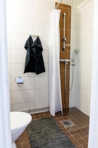 a bathroom with a shower with a shower curtain at Bright apartment in the Center in Kajaani