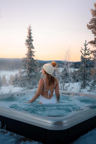 a woman in a hot tub in the snow at The Fell in Levi
