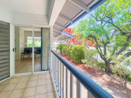 a balcony with a view of a living room at Tropic Drift in Airlie Beach