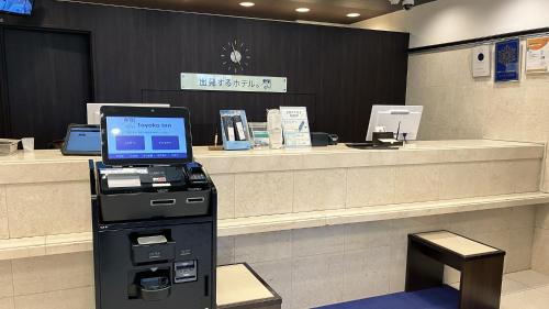an atm machine in a store with a cash register at Toyoko Inn Kokura eki Shinkansen guchi in Kitakyushu