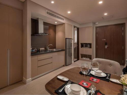 a kitchen and dining room with a table with wine glasses at DN ALT sentafe ppt in Danang