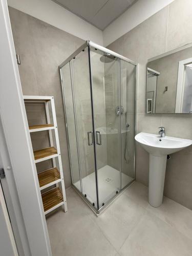 a bathroom with a glass shower and a sink at Viva Residence in Calderara di Reno