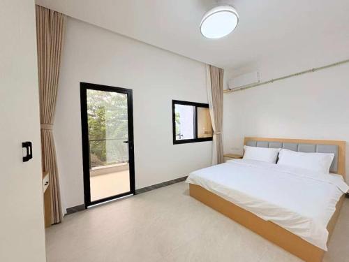 a bedroom with a bed and a large window at Xiaos Henderson Hotel in Lungga