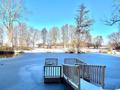 two benches sitting in the middle of a frozen lake at Ferienwohnung Domaene Kermen in Kermen
