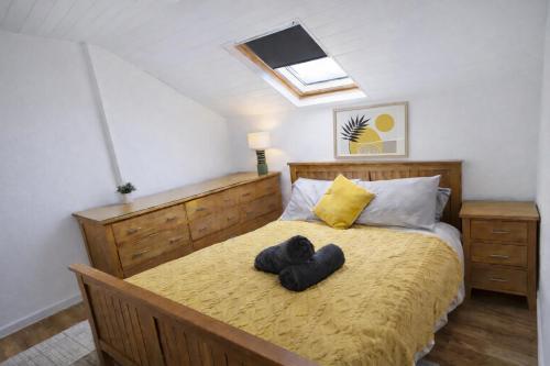 a bedroom with a bed with two towels on it at Spacious Penthouse in Central Plymouth 3 Large Bedrooms in Plymouth