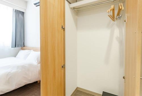 an open door to a bedroom with a bed at Hopetree 天王寺 in Osaka