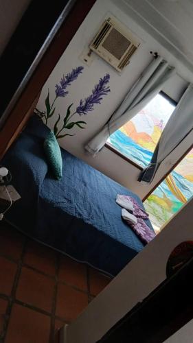 a room with a bed and two windows at Ganesha do mar in Búzios