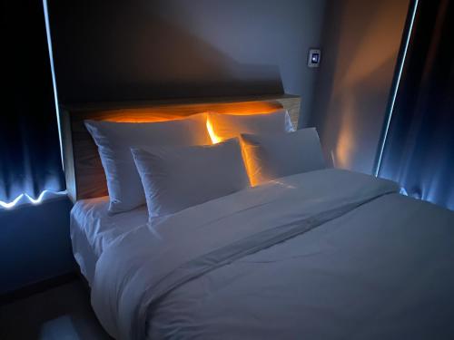 a bed with white sheets and pillows in a room at Sky Star in Incheon