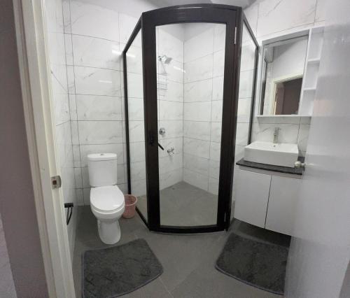 a bathroom with a shower and a toilet and a sink at 2 bedroom Flat in Namaka,Nadi in Nadi