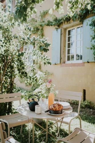 a table with a plate of food and a candle at Domaine La Commanderie in Boersch
