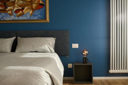 a bedroom with a bed and a blue wall at Le Mura Minicase int 3 in Castelfranco Veneto