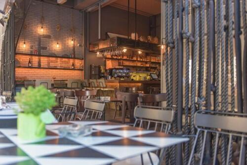 a dining room with tables and chairs in a restaurant at iFeel Athens Suites in Athens