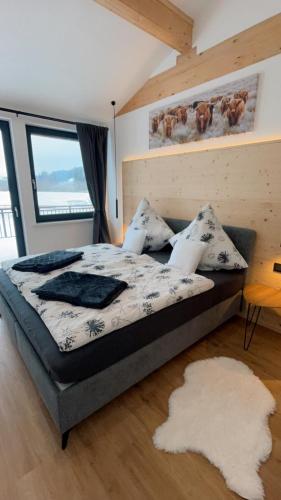 a bedroom with a bed and a large window at Moosmühle Weitnau in Weitnau