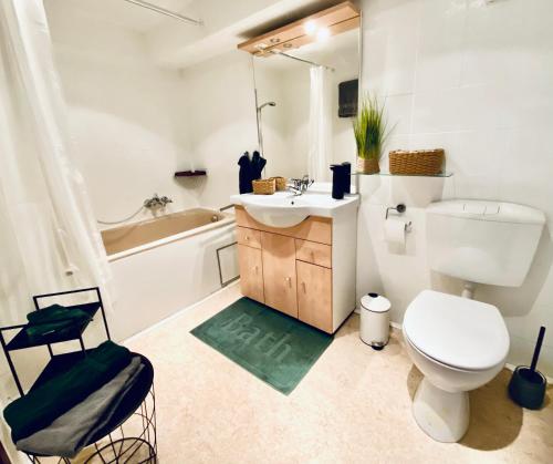 a bathroom with a toilet and a sink and a tub at Moosmühle Weitnau in Weitnau