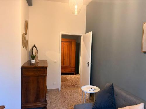 a living room with a couch and a wooden door at GuestHouse Modena Buon Pastore in Modena