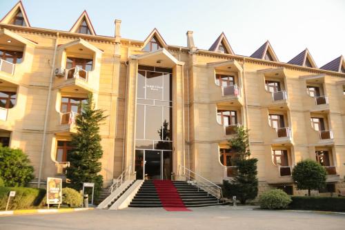 a building with a red carpet in front of it at Gabala Yeddi Gozel Hotel in Gabala