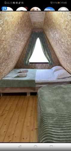 a bedroom with a bed and a window in it at Altimo კოტეჯი ალტიმო in Norio