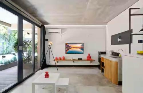 a kitchen with white walls and a large window at Modern Apartment with Shared Pool - By the Beach in Seminyak