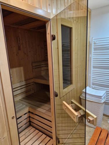 a wooden sauna with a glass door in a room at Chata pod Kykulou in Oščadnica