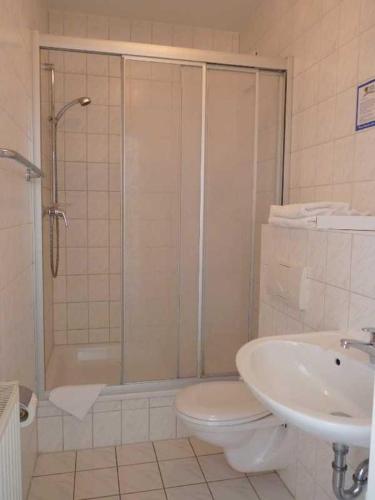 a bathroom with a shower and a toilet and a sink at Hotel Prignitz in Wittenberge