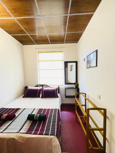a bedroom with two beds and a window at Anu Home Stay in Ahangama