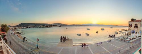 a group of people walking around a body of water at Midilli Konak Foca in Foça