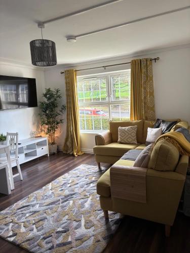 a living room with a couch and a table at Park View Apartment Newry in Newry