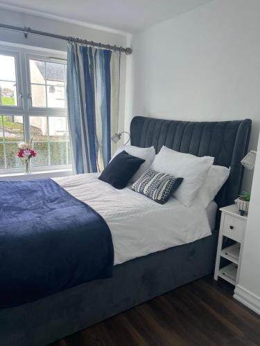 a bed with two pillows on it in a bedroom at Park View Apartment Newry in Newry