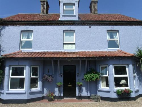 a blue house with a red roof at Hooray Henrys Sheringham in Sheringham