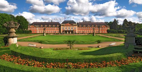 a large building with a garden in front of it at Royal Apartmány in Dobříš