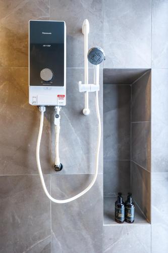 a cell phone hooked up to a wall at Mossaz Suites by Mana Mana in Petaling Jaya