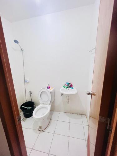 a bathroom with a toilet and a sink at Sparrow Transient Townhouse in Davao City