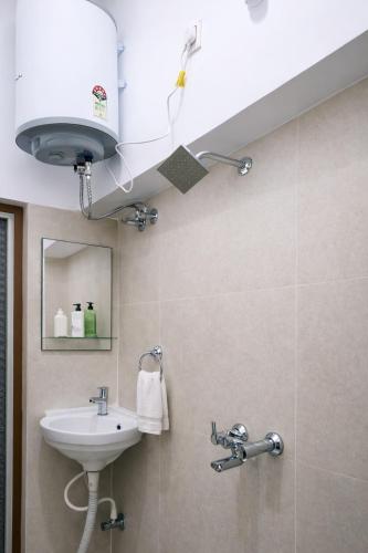 a bathroom with a sink and a mirror at Ekaay The Boutique Hotel in Kumārkara