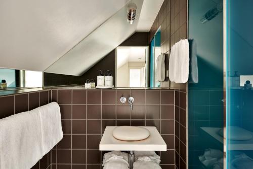 a bathroom with a toilet and a sink at Hotel Skeppsholmen, Stockholm, a Member of Design Hotels in Stockholm