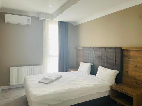 a bedroom with a large bed with two towels on it at Centrum Hotel in Ankara