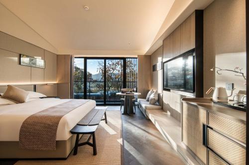a hotel room with a bed and a large window at cloud retreat·half an ocean hotel in Zhoushan