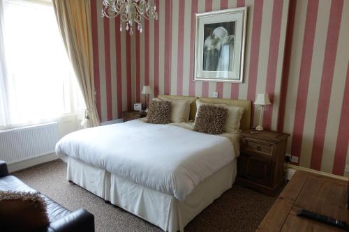 a bedroom with a bed and red and white stripes at Oakover Guest House in Weston-super-Mare