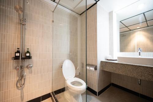 a bathroom with a toilet and a sink and a shower at Town in Town Hotel Bangkok in Bangkok