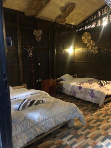 a bedroom with two beds in a room at NYUNGWE ECOLODGE - Gisakura in Nyamasheke