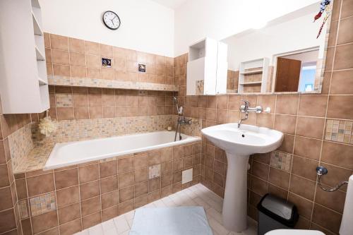 a bathroom with a tub and a sink and a bath tub at Apartmán Absolon Blansko in Blansko